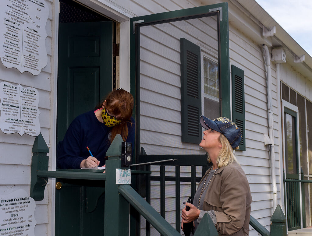 Katie Shannon, right, orders lunch to go from an employee